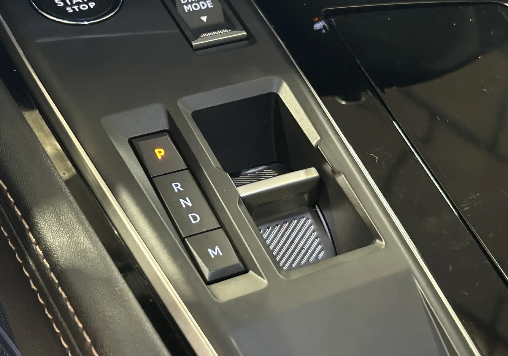 Gros plan sur la console centrale de la Peugeot 508 SW 2024, montrant la commande de boîte auto et le bouton Drive Mode.