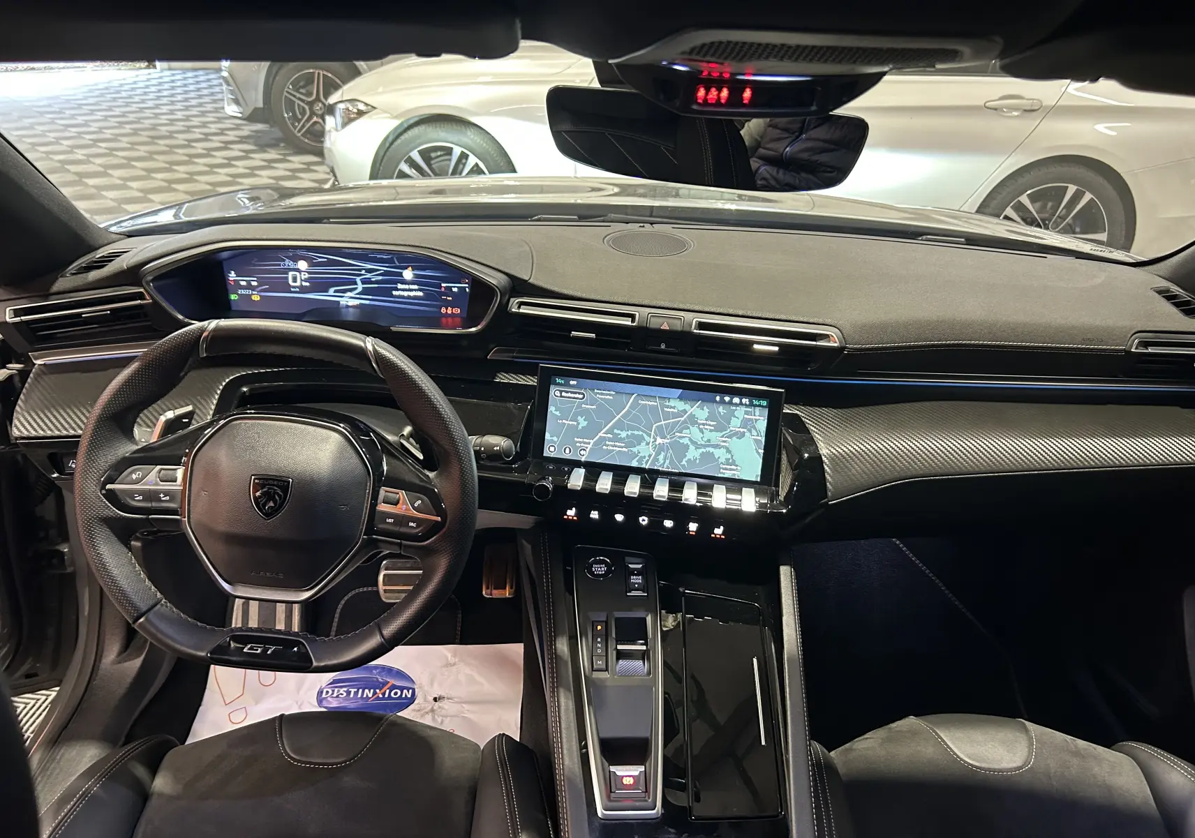 Vue intérieure avant du Peugeot 508 SW gris Selenium 2024, tableau de bord numérique et écran tactile avec navigation.