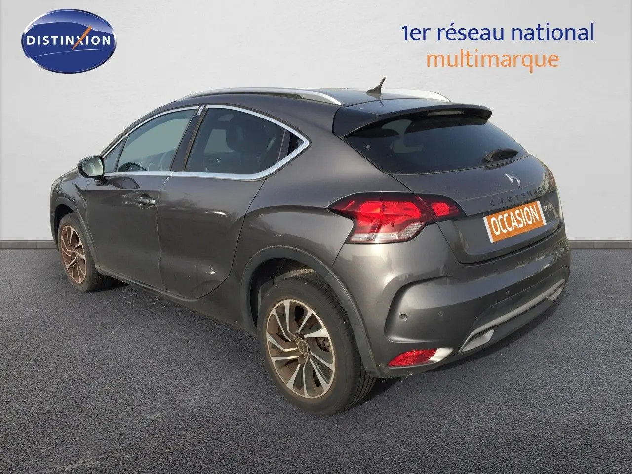 Vue 3/4 arrière droite d'une DS4 CROSSBACK gris platinium métallisé avec jantes bi-ton et feux LED distinctifs.