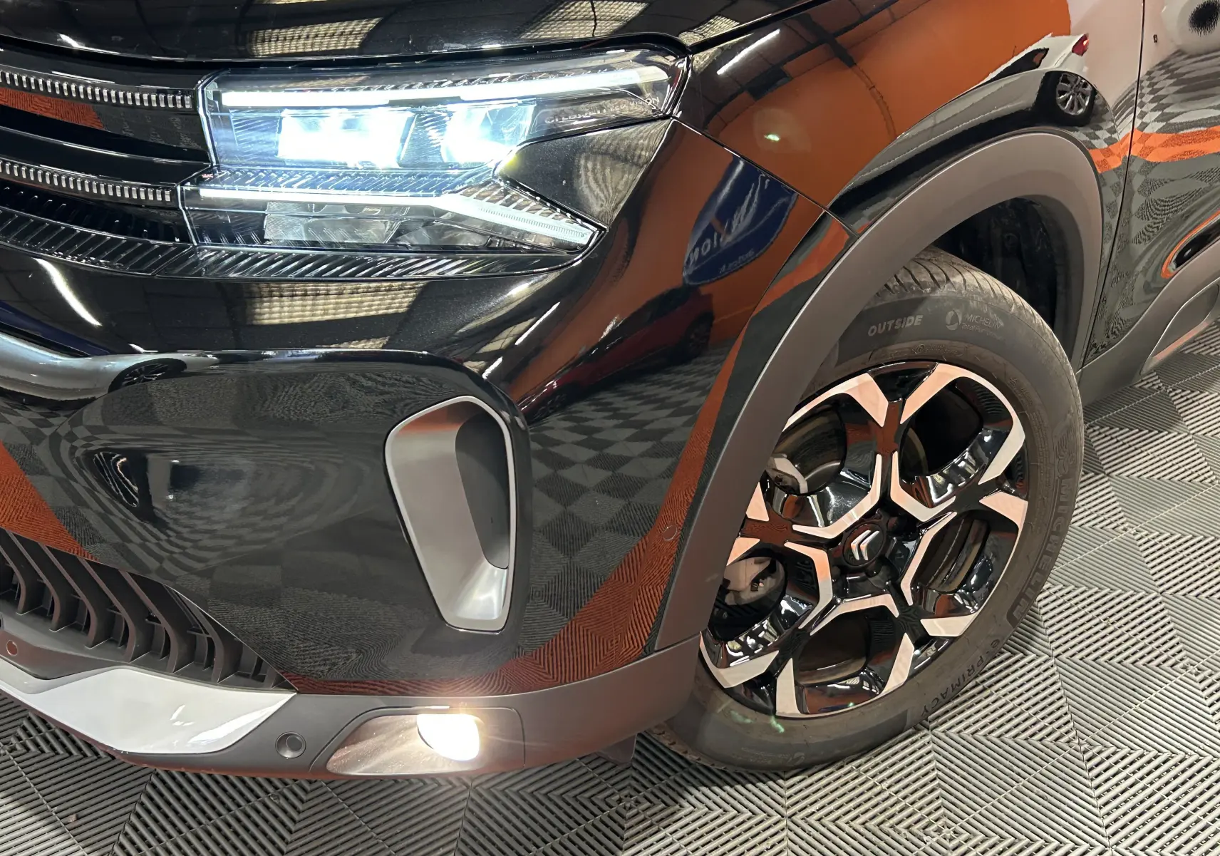 Gros plan sur l'avant droit noir Perla Nera du Citroën C5 Aircross Ph.2 MAX Hybride avec feux LED et jante alliage distinctive.