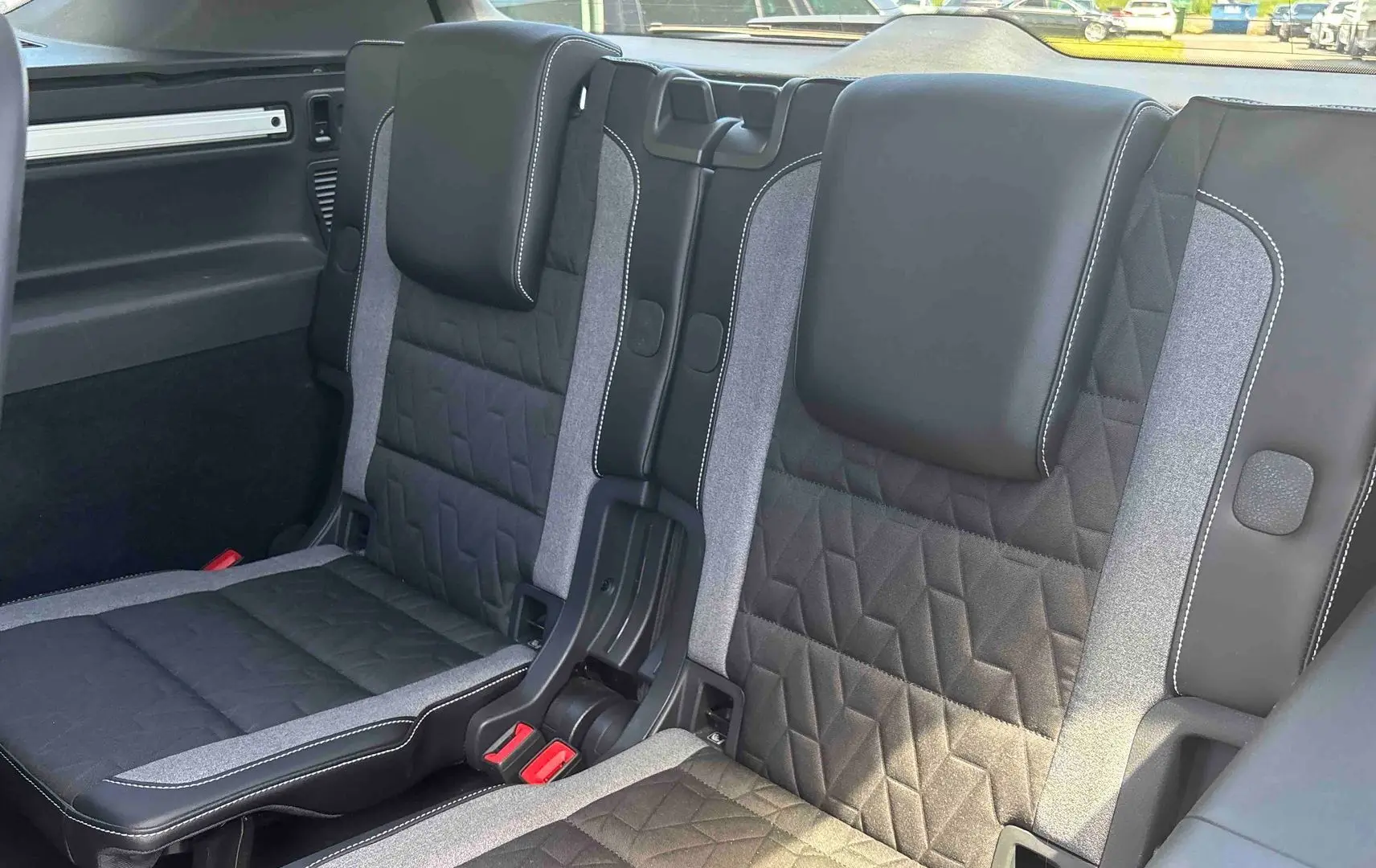 Vue rapprochée des sièges arrière en tissu noir et gris du Volkswagen Touran 2025, version 7 places.