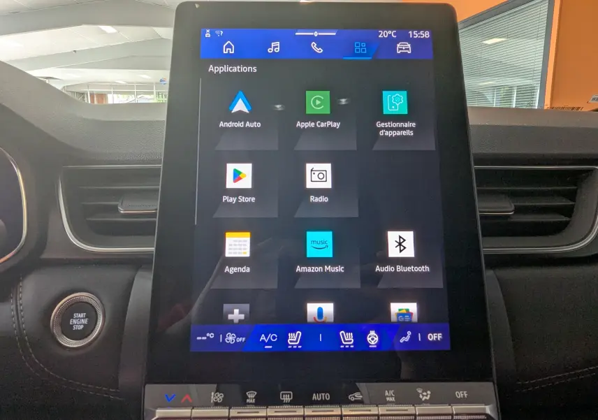 Vue rapprochée de l'écran tactile central du Renault Symbioz gris cassiopée, affichant les applications multimédia et climatisation.