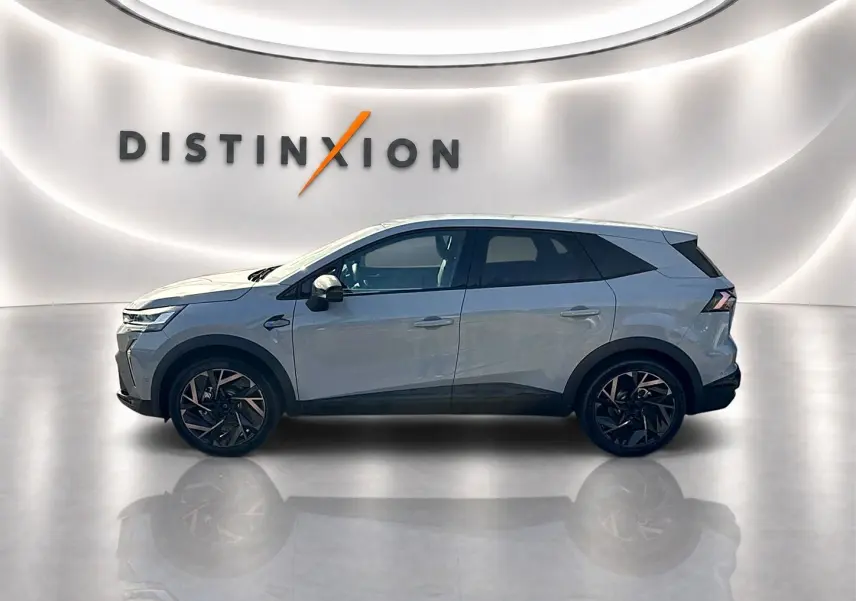 Renault Symbioz gris rafale en profil droit dans un showroom lumineux avec jantes noires distinctives.