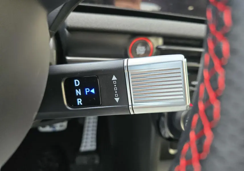 Gros plan sur la commande de boîte automatique argentée avec affichage digital bleu dans l'habitacle du Hyundai Tucson N Line.