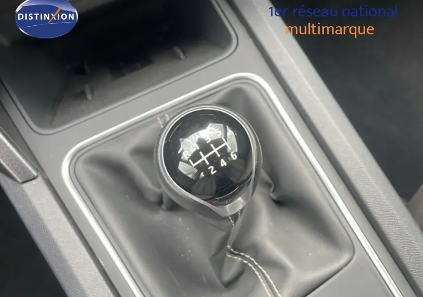 Gros plan sur le levier de vitesses manuel noir de la SEAT LEON 2.0 TDI, entouré de garniture grise intérieure.