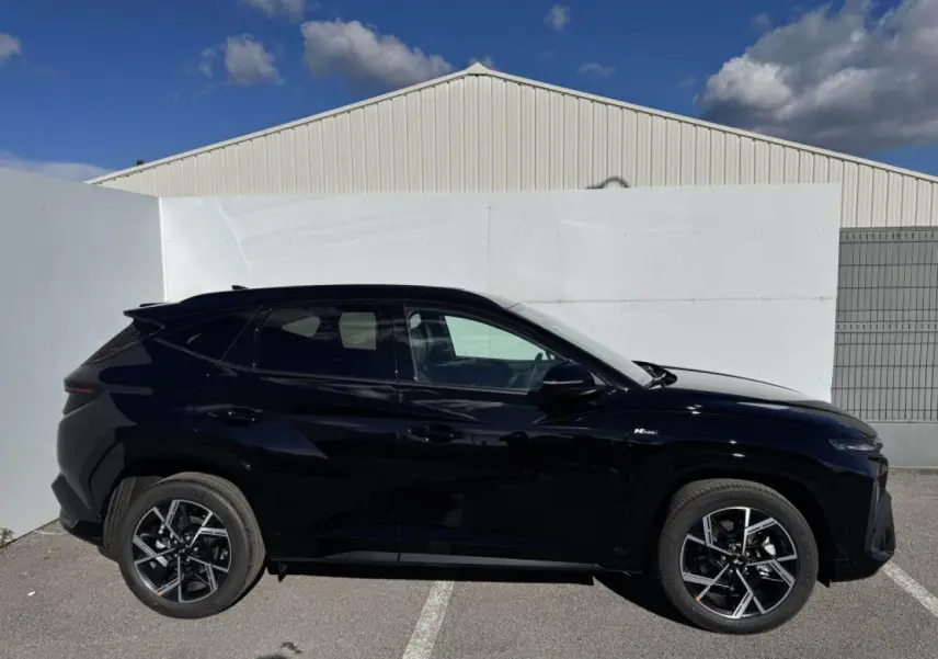 Vue latérale droite du Hyundai Tucson noir Abyss Metal avec jantes alliage 19'' N Line et vitres surteintées.
