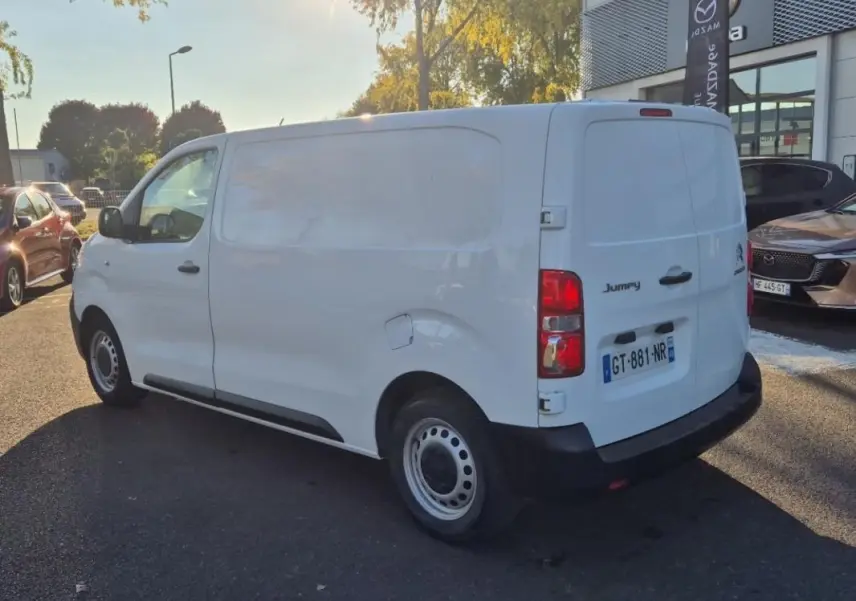 Vue 3/4 arrière droite d’un Citroën Jumpy blanc utilitaire, avec portes arrière pleines et jantes acier simples.
