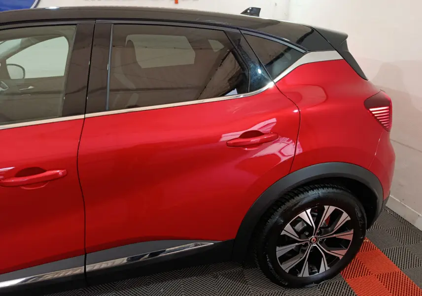 Profil côté gauche du Renault Captur rouge 2024 avec toit noir et jantes alliage distinctives.