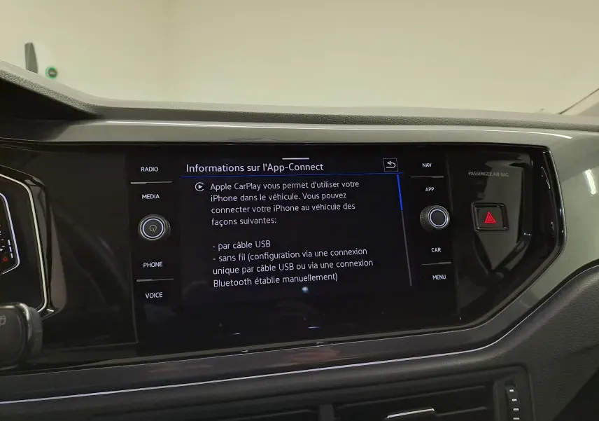 Écran tactile central affichant les options Apple CarPlay dans l’habitacle d’une Volkswagen Polo gris cendré.