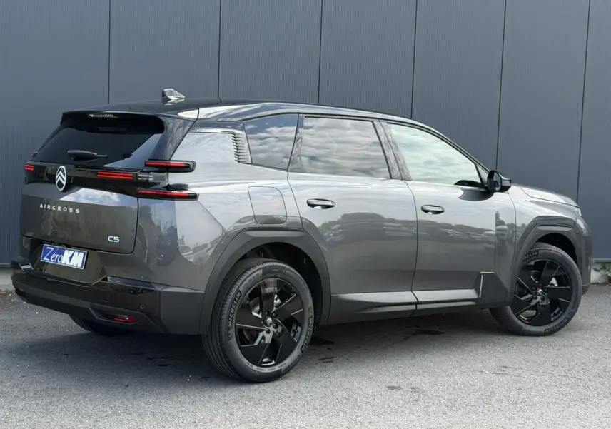 Vue 3/4 arrière droite du Citroën C5 Aircross gris Platinium avec toit noir et jantes alliage noires.