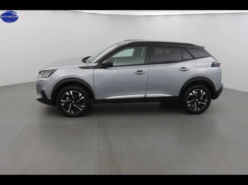 Profil droit du Peugeot 2008 1.2 PureTech 130ch GT 2023 en gris Artense avec toit noir et jantes alu noires.
