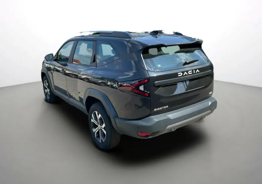 Vue 3/4 arrière droite du Dacia Bigster noir perle avec barres de toit et jantes alu 17 pouces visibles.