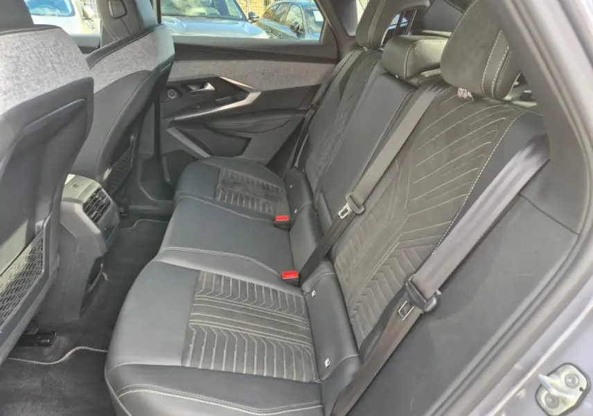 Vue côté droit de la banquette arrière gris clair du Peugeot 3008 Hybrid 136 e-DCS6 GT avec sellerie mixte cuir et tissu.