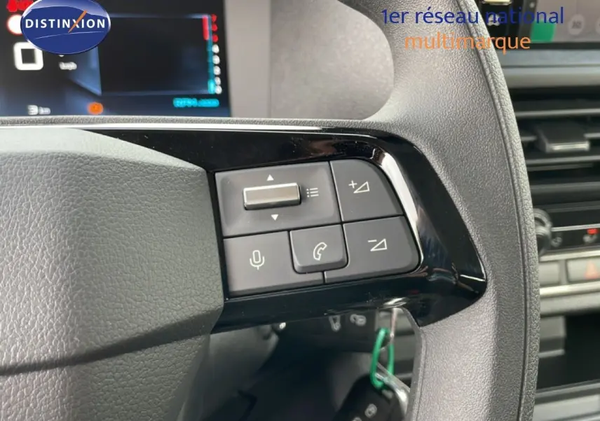 Gros plan sur les commandes au volant du Citroën Jumpy cabine approfondie, finition noire avec écran digital en arrière-plan.