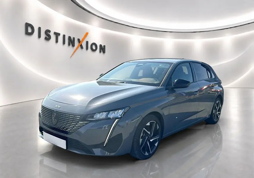 Peugeot 308 gris Artense vue 3/4 avant droit dans un showroom lumineux avec jantes alliage noires et grises.