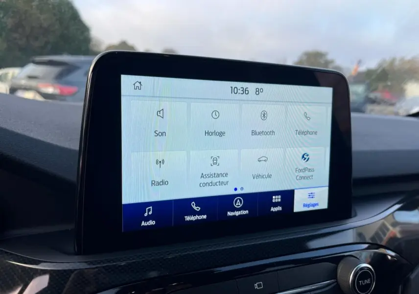 Écran tactile central du Ford Kuga 1.5 EcoBoost 2022 affichant les options audio et navigation, intérieur noir.