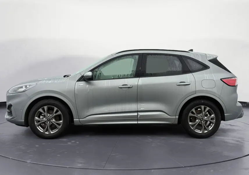 Vue latérale droite d'un Ford Kuga gris 2024, version hybride ST-Line X avec jantes alliage distinctives.