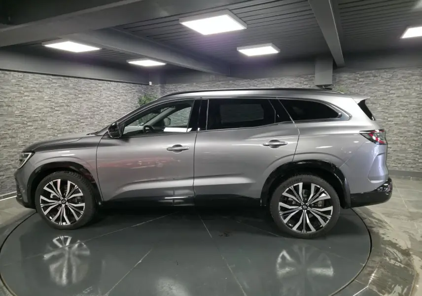 Profil côté gauche du Renault Espace 2025 gris Baltique avec jantes alliage 20 pouces et vitres surteintées.