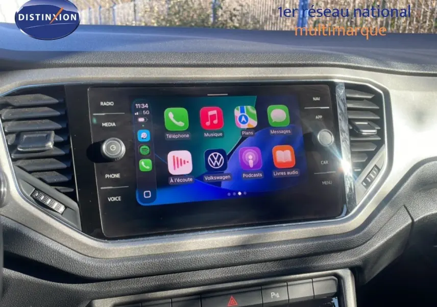 Écran tactile central avec interface Apple CarPlay dans l’habitacle du Volkswagen T-Roc bleu Ravenna Metal.