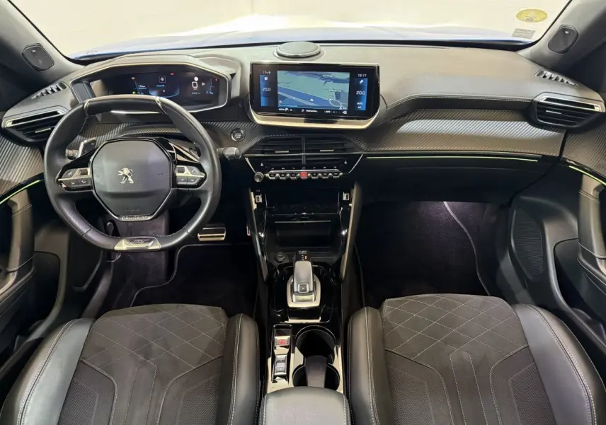 Vue intérieure avant du Peugeot 2008 GT Pack 2021, tableau de bord moderne avec écran tactile et volant cuir multifonctions.