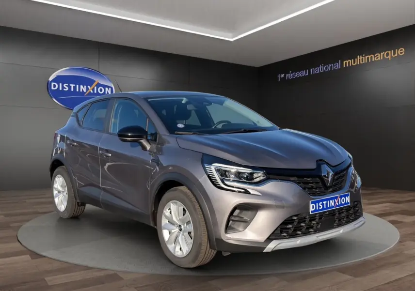 Renault Captur gris foncé en vue 3/4 avant droit, avec calandre noire et phares LED distinctifs.