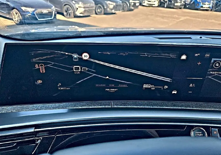 Vue intérieure du tableau de bord numérique du Peugeot 5008 Hybrid 145 allure e-dcs6 avec affichage de navigation et indicateurs.