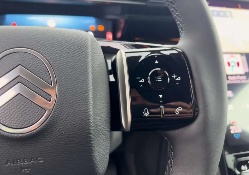 Gros plan sur le volant cuir multifonctions du Citroën C5 Aircross Hybrid 2026 avec commandes vocales et appel.
