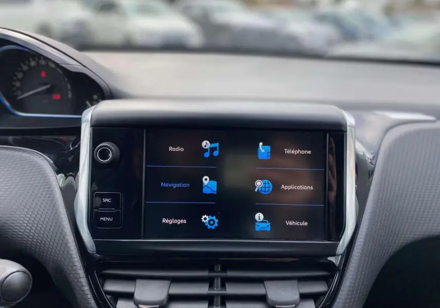 Vue rapprochée du tableau de bord du Peugeot 2008 gris platinium, avec écran tactile affichant les options de navigation et téléphone.