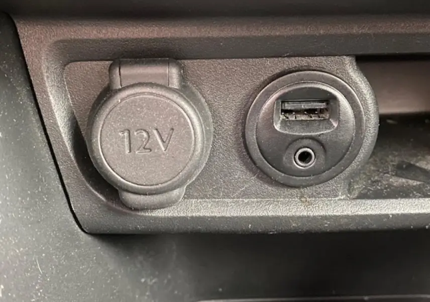 Prise 12V et port USB avec entrée audio en gros plan dans l’habitacle d’une Peugeot 2008 GT Line gris platinium.