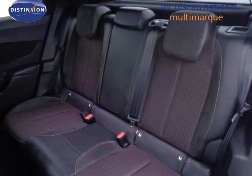Vue intérieure sur la banquette arrière du DS3 Crossback avec sièges en tissu et cuir noir, appuie-têtes et ceintures visibles.