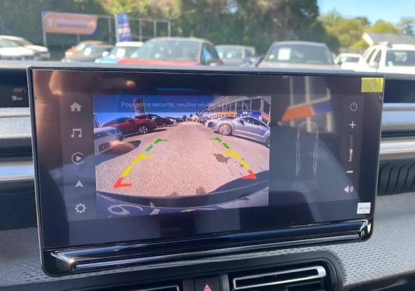 Écran central tactile montrant la caméra de recul d’un Citroën C3 Aircross gris Mercury au stationnement.