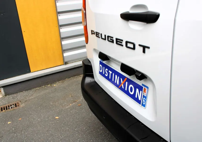 Gros plan sur l'arrière droit blanc du Peugeot Partner Fourgon 2025 avec logo et plaque d'immatriculation Distinxion.