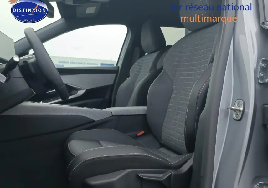 Vue intérieure côté conducteur du Peugeot 5008 gris artense, mettant en valeur les sièges tissu et cuir bicolores.