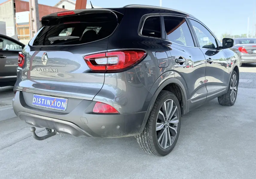 Renault Kadjar gris en 3/4 arrière droit, avec attelage de remorque visible et jantes alliage.