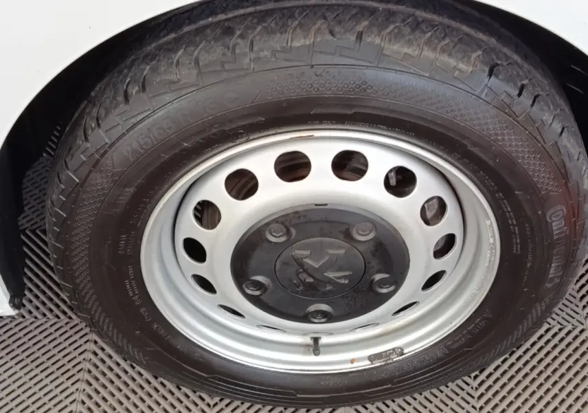 Gros plan sur la roue avant droite du Peugeot Expert Fourgon blanc, mettant en valeur la jante acier et le pneu Continental.