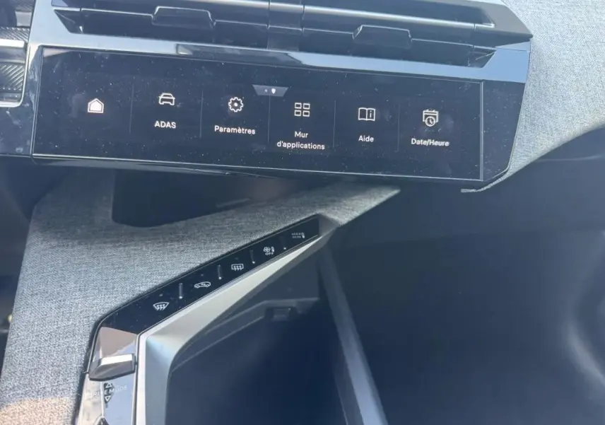 Vue rapprochée de la console centrale et écran tactile du Peugeot 3008 Hybrid gris foncé, mettant en valeur les commandes digitales.