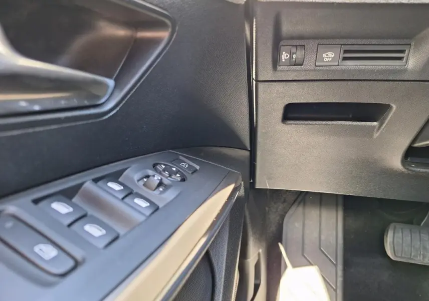Détail des commandes des vitres et rétroviseurs côté conducteur du Peugeot 3008 Hybrid gris foncé, intérieur noir.