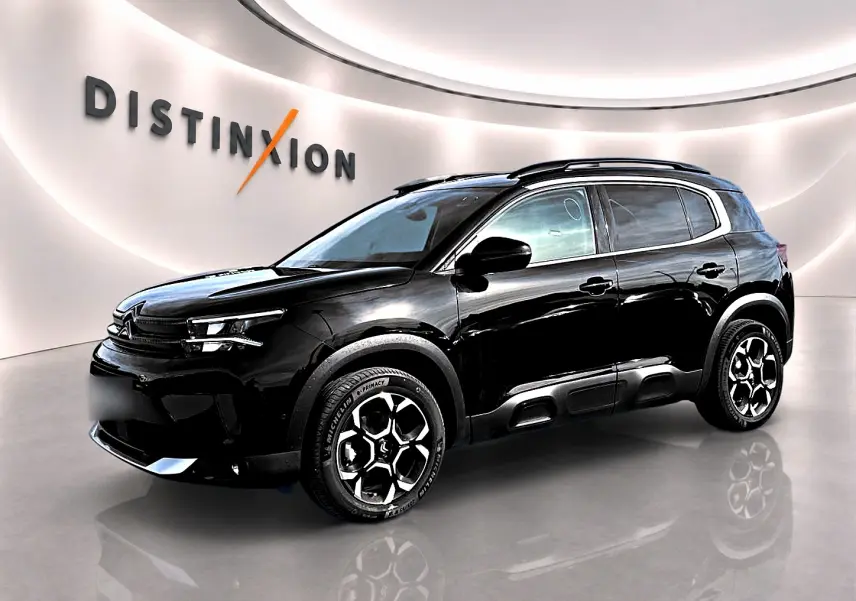 SUV Citroën C5 Aircross noir en vue 3/4 avant droit, avec jantes alu et barres de toit visibles.