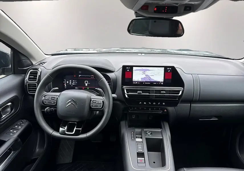 Vue intérieure avant du Citroën C5 Aircross 2025, tableau de bord noir avec écran tactile et volant multifonction.