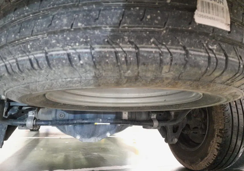 Gros plan sous le Renault Master blanc 2024 montrant la roue de secours et le train arrière avec suspension.