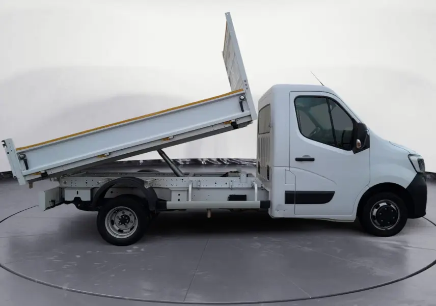 Vue latérale droite d’un Renault Master blanc 2024 avec benne basculante relevée, cabine simple et jantes acier.