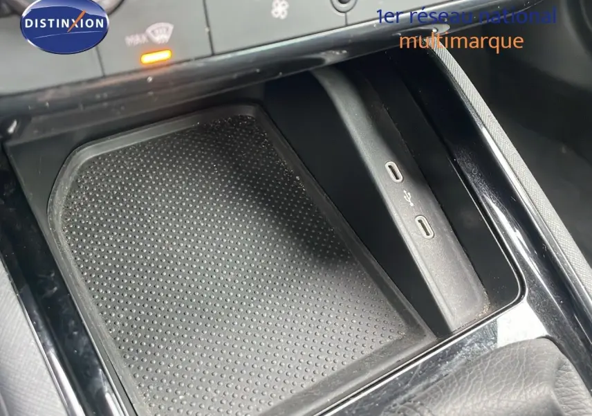 Gros plan sur la console centrale du Skoda Kamiq 2024 rouge velvet, montrant les ports USB et le rangement antidérapant.