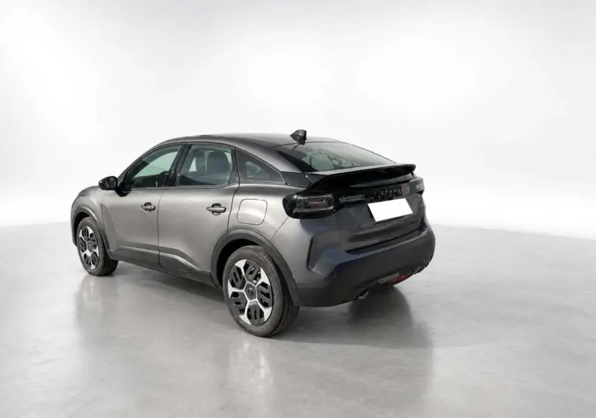 Vue 3/4 arrière droite d'une Citroën C4 hybride 2025 gris mercury avec jantes acier 18 pouces et feux arrière foncés.