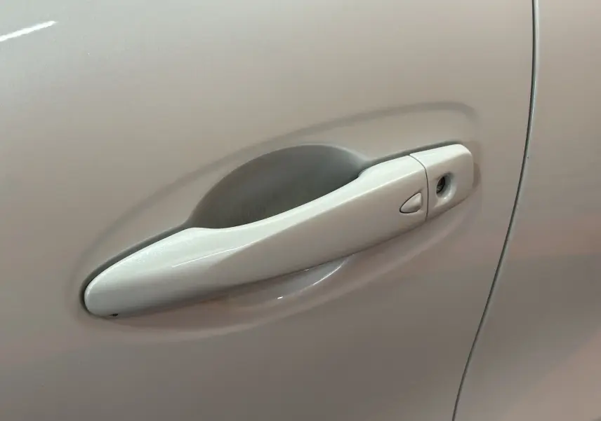 Poignée de porte avant droite blanche du Renault Kadjar TCE 130 Energy Intens EDC 2018, vue rapprochée.