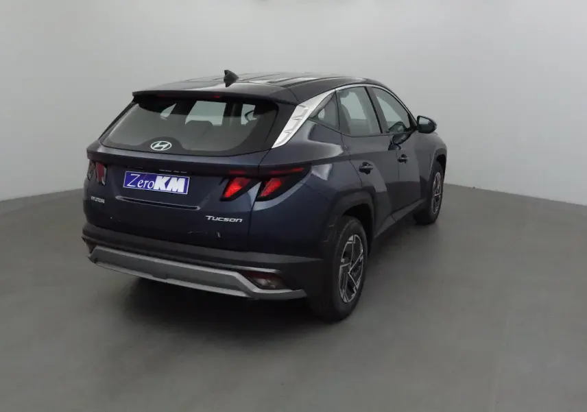 Vue 3/4 arrière droite du Hyundai Tucson 2025 bleu Salling avec feux arrière au design anguleux et jantes alliage.