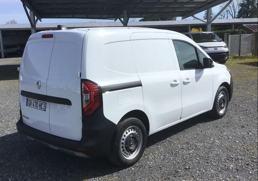 Vue 3/4 arrière droite d’un Renault Kangoo Van blanc 2024 avec portes arrière battantes et feux LED distinctifs.