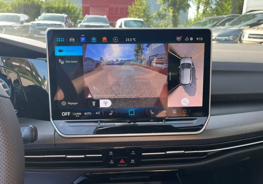 Écran tactile central affichant la caméra 360° et l’aide au stationnement dans l’habitacle d’une Volkswagen Golf gris dauphin.
