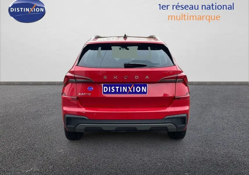 Vue arrière d'un Skoda Kamiq rouge Velvet Metal 2024 avec logo SKODA et plaque Distinxion visible.