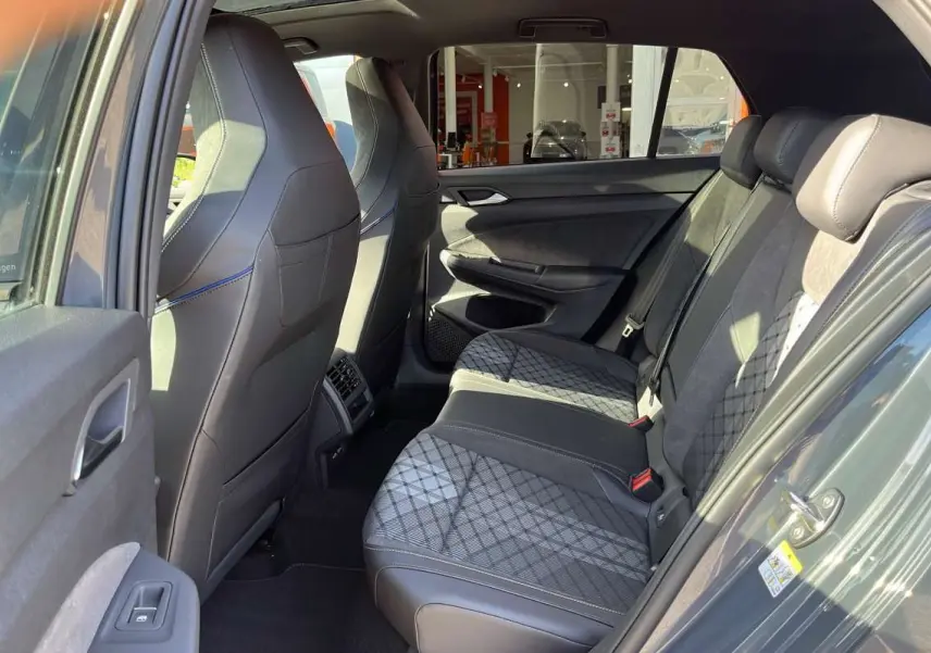 Vue intérieure côté gauche de la banquette arrière en tissu et cuir gris avec surpiqûres sur une Volkswagen Golf gris dauphin.