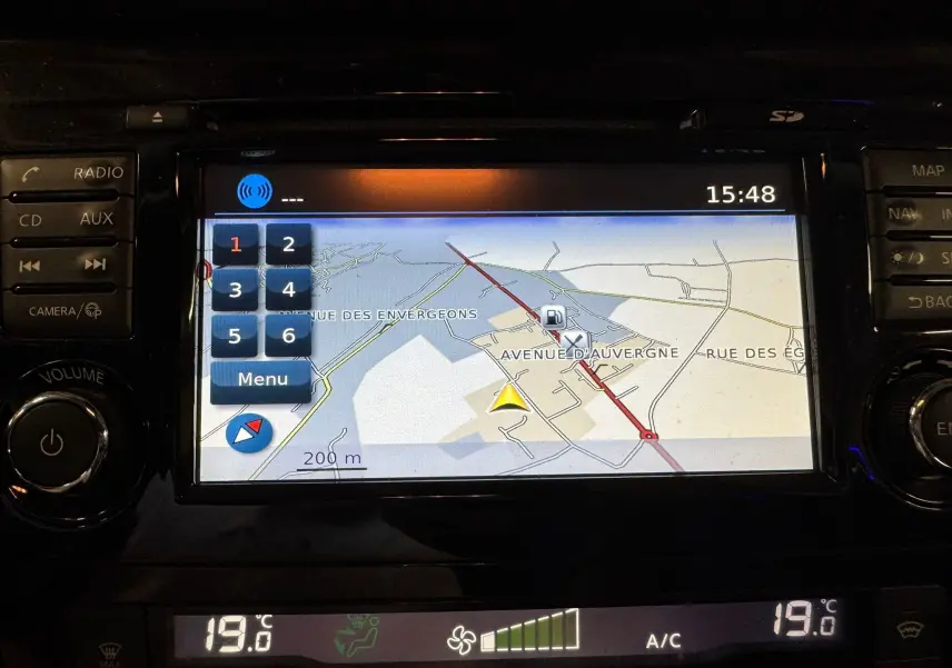 Écran tactile du GPS du Nissan Qashqai noir, affichant une carte avec options de menu et température à 19°C.
